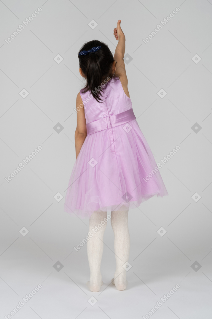 Back view of a little girl giving thumbs up