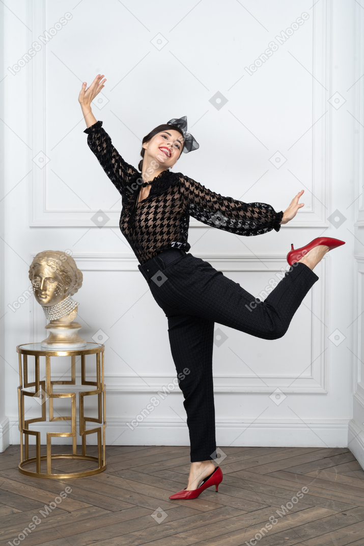 Portrait of a cheerful young woman dancing happily