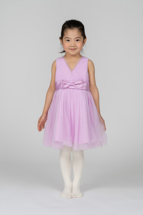 Cute little girl showing off her dress