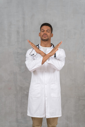 Male doctor making a stop gesture