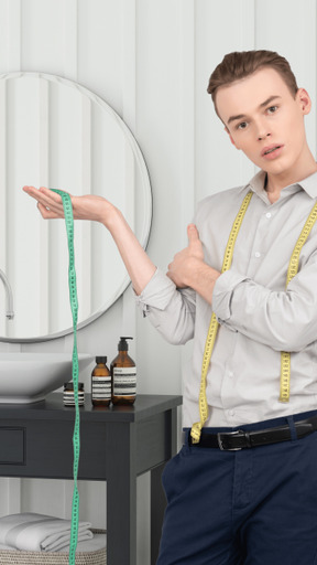 A man holding a measuring tape in front of a mirror