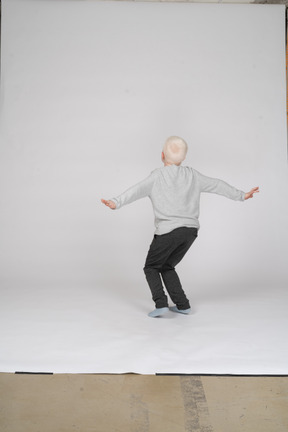 Back view of a boy spinning around