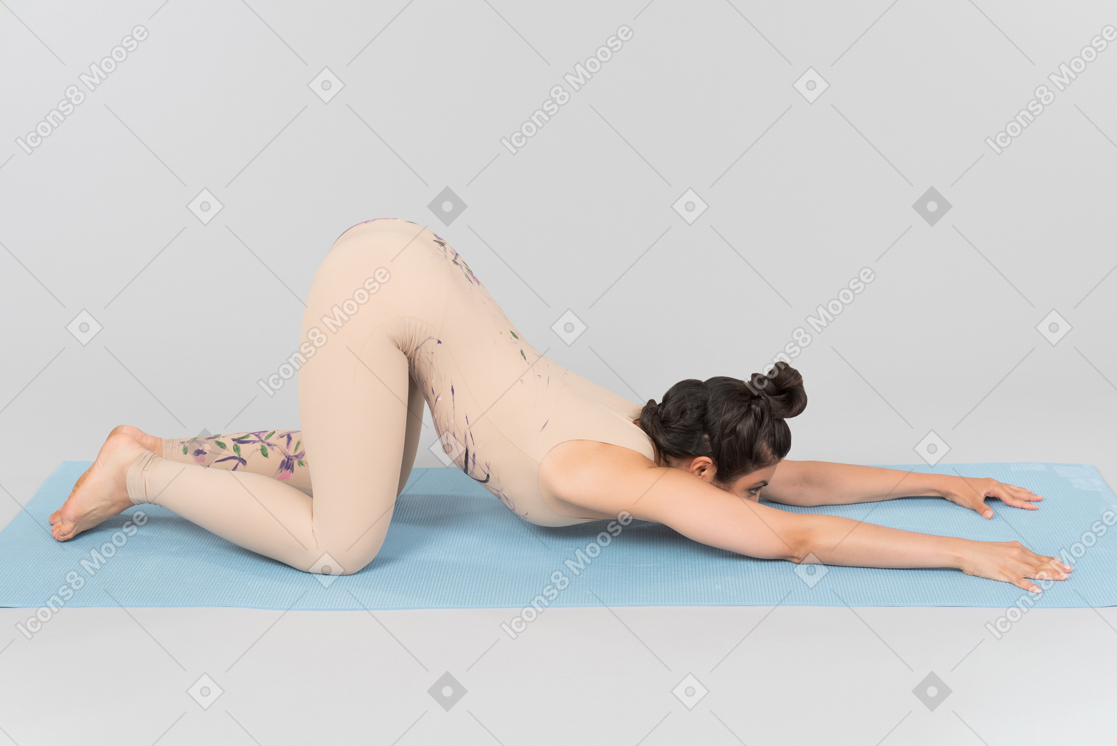 Young indian woman standing in pose on yoga mat