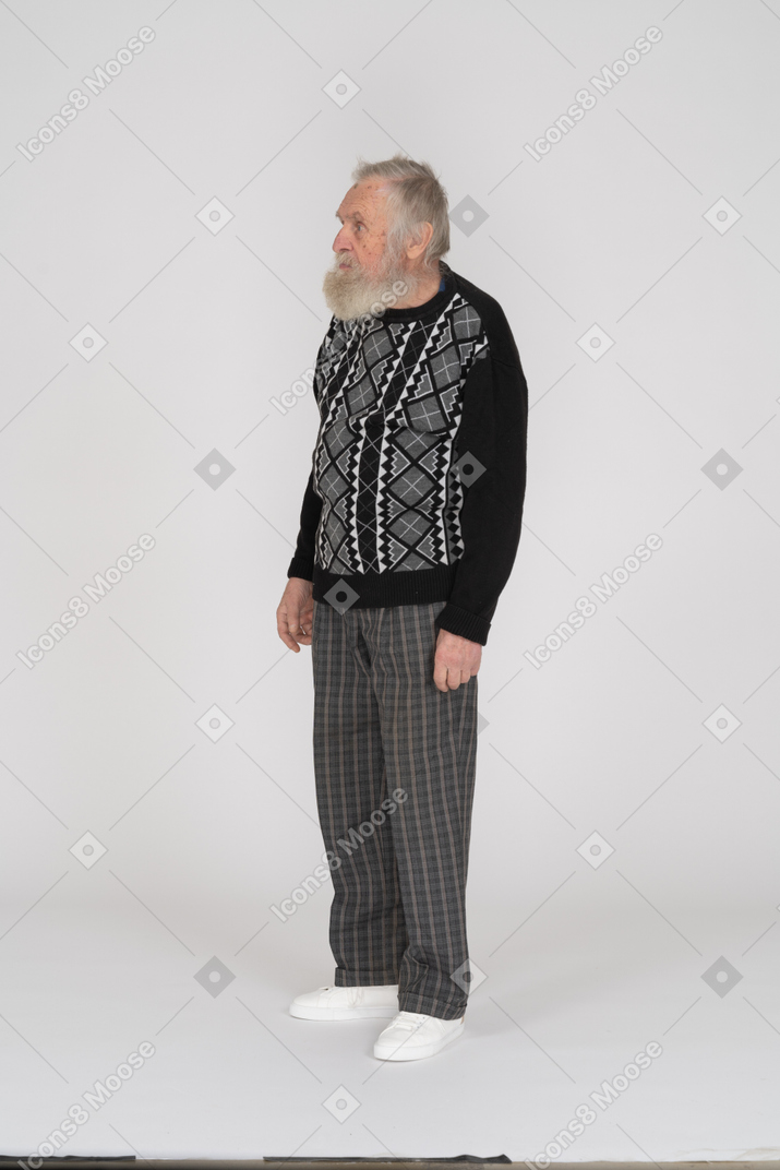 Old man in dark clothes standing still