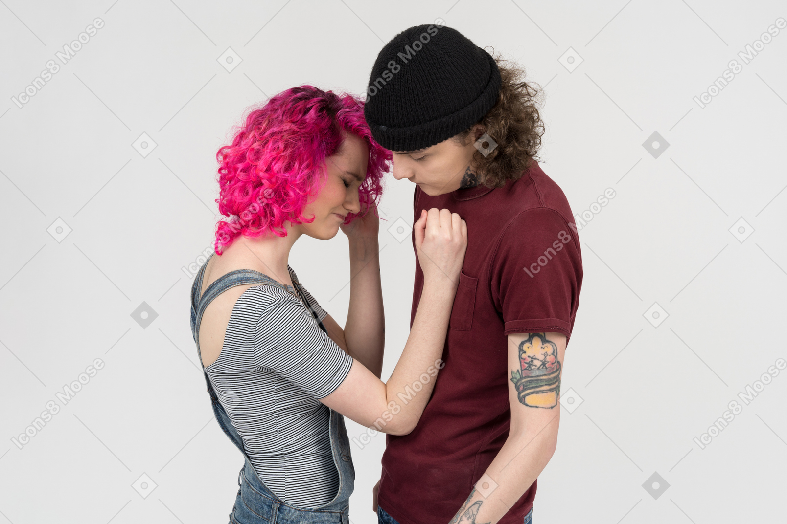 Young female stands next to her boyfriend crying