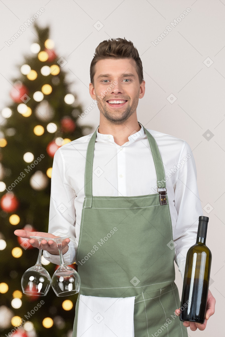 Young man offering christmas wine