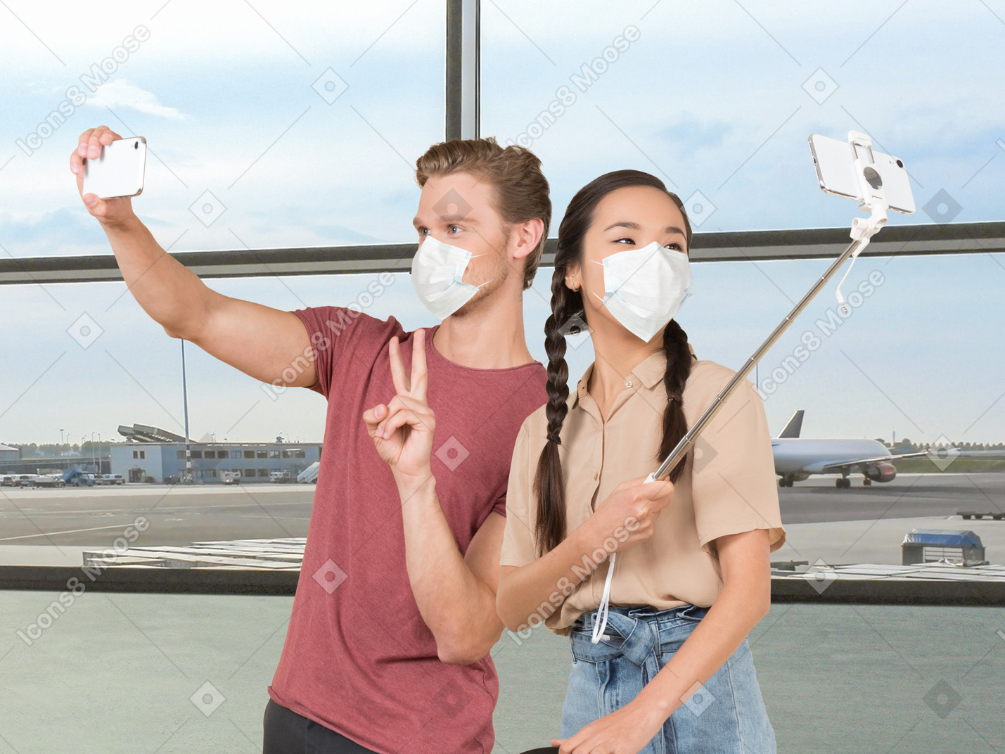 A young man and a young woman wearing face masks and taking selfies