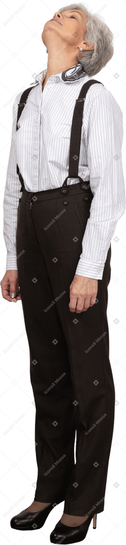 Three-quarter view of an old lady in office clothing throwing head back
