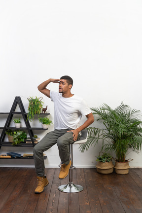 Good looking young man sitting on a chair