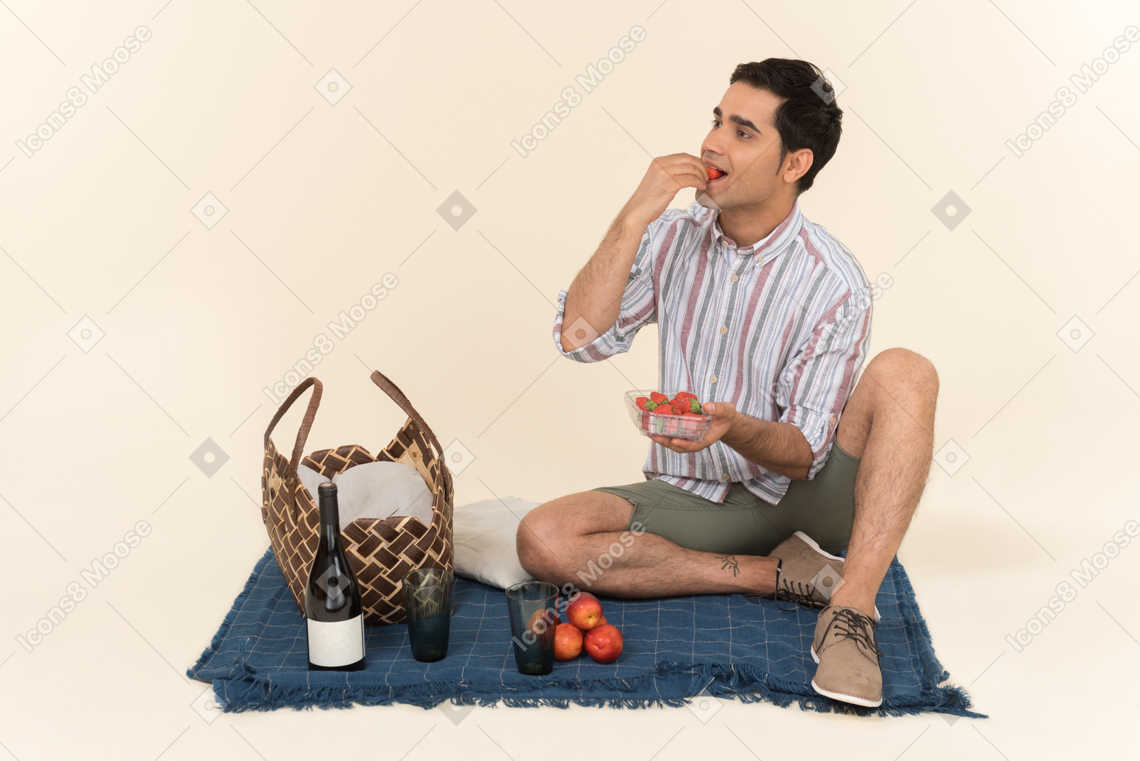 Young caucasian man eating strawberries