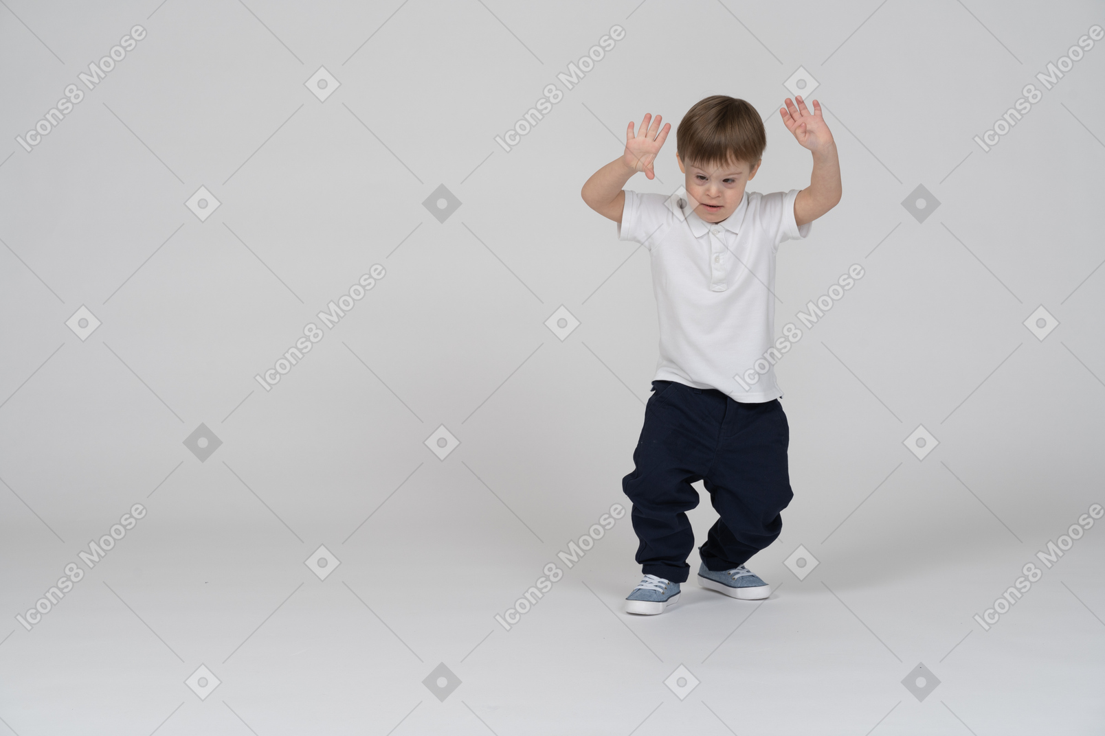 Front view of a boy squatting slightly with raised hands