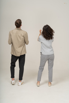 Man and woman standing with their backs to the camera