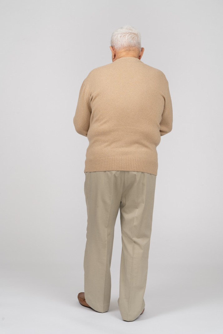 Rear view of an old man in casual clothes Photo