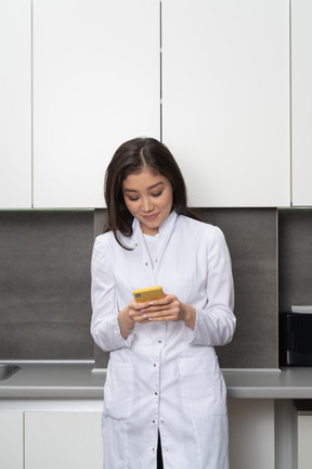 Front view of a female nurse chatting via phone