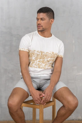 Man on stool looking aside
