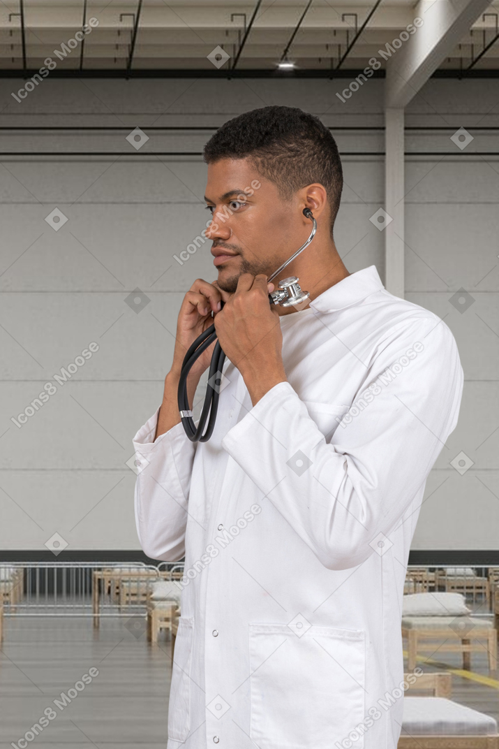 Man in a white lab coat with a stethoscope