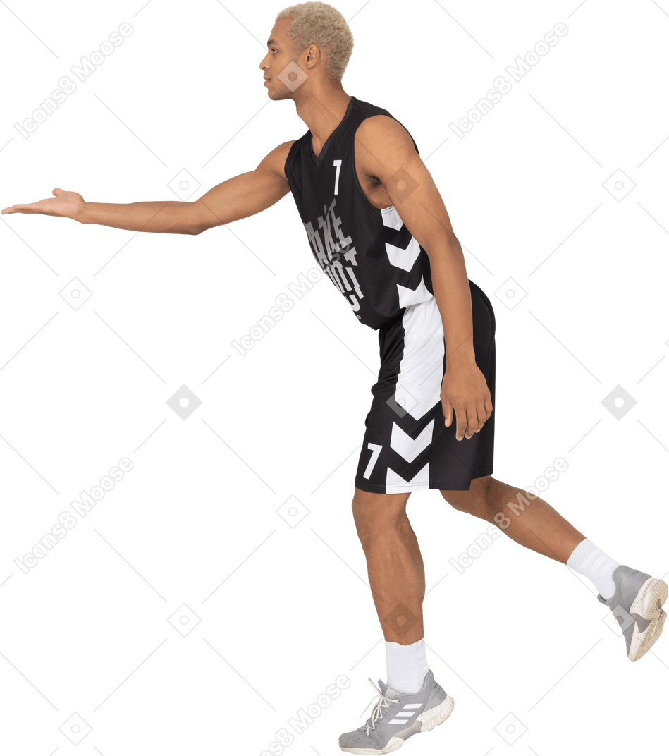 Side view of a young male basketball player outstretching hand
