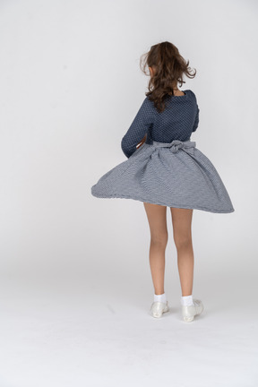 Rear view of a girl twirling in a skirt