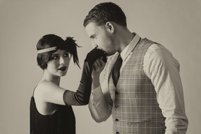 Gentleman kissing a hand of a beautiful well-dressed woman
