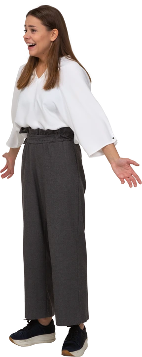 Three-quarter view of a laughing young lady in office clothing outspreading arms