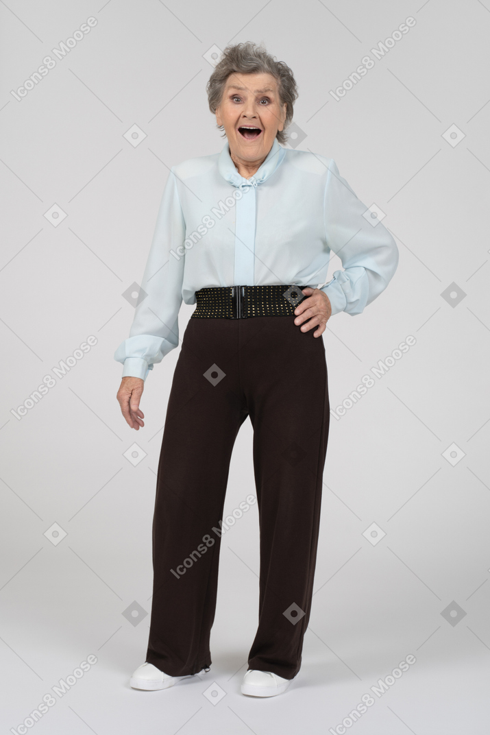 Front view of an old woman looking surprised and happy