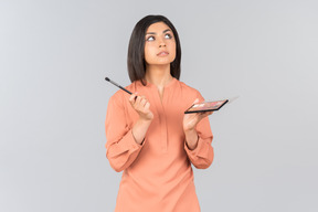 Indian woman holding eyeshadow and eye brush