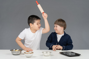 Dos niños pequeños divirtiéndose mientras cocina