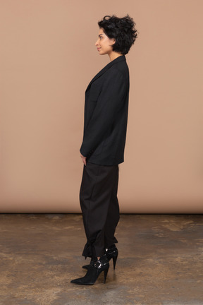 Side view of a smiling businesswoman in a black suit
