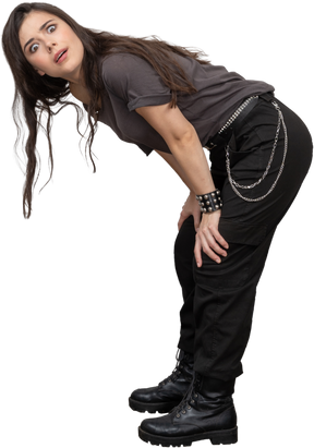 Side view of a questioning female rocker bending down