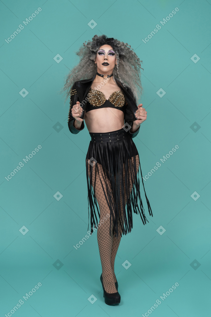 Drag queen opening jacket while posing