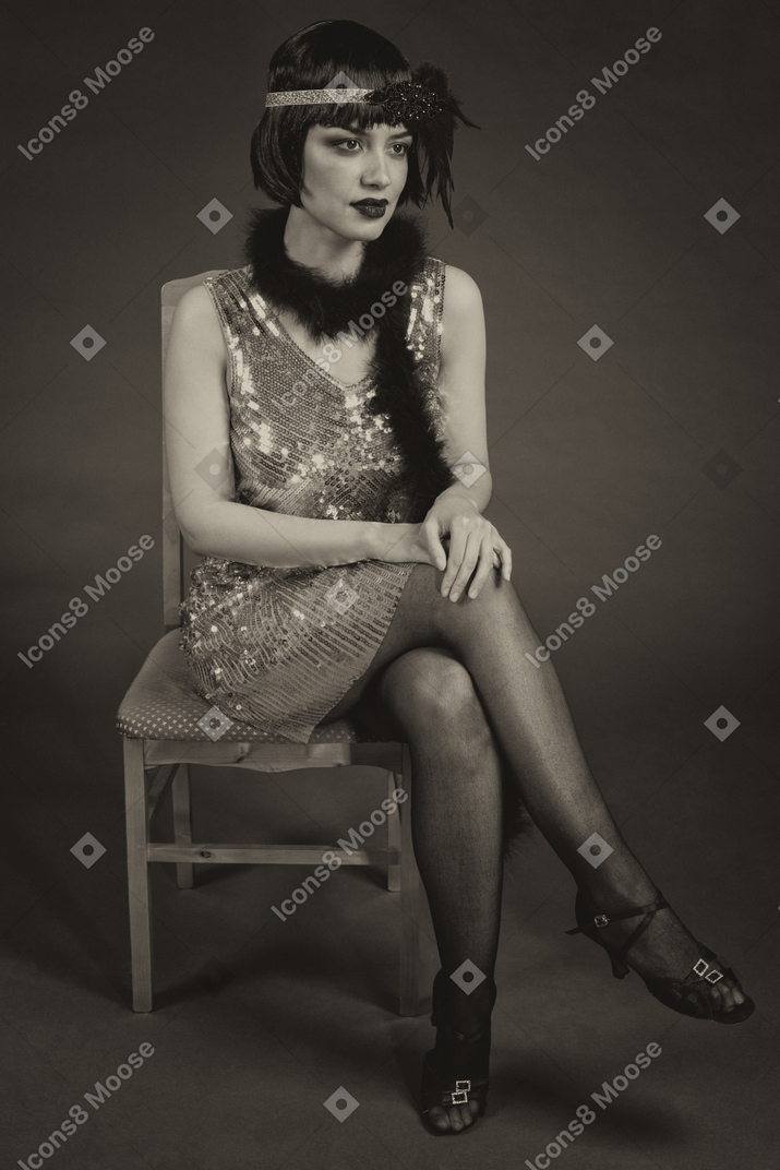Beautiful flapper sitting on a chair