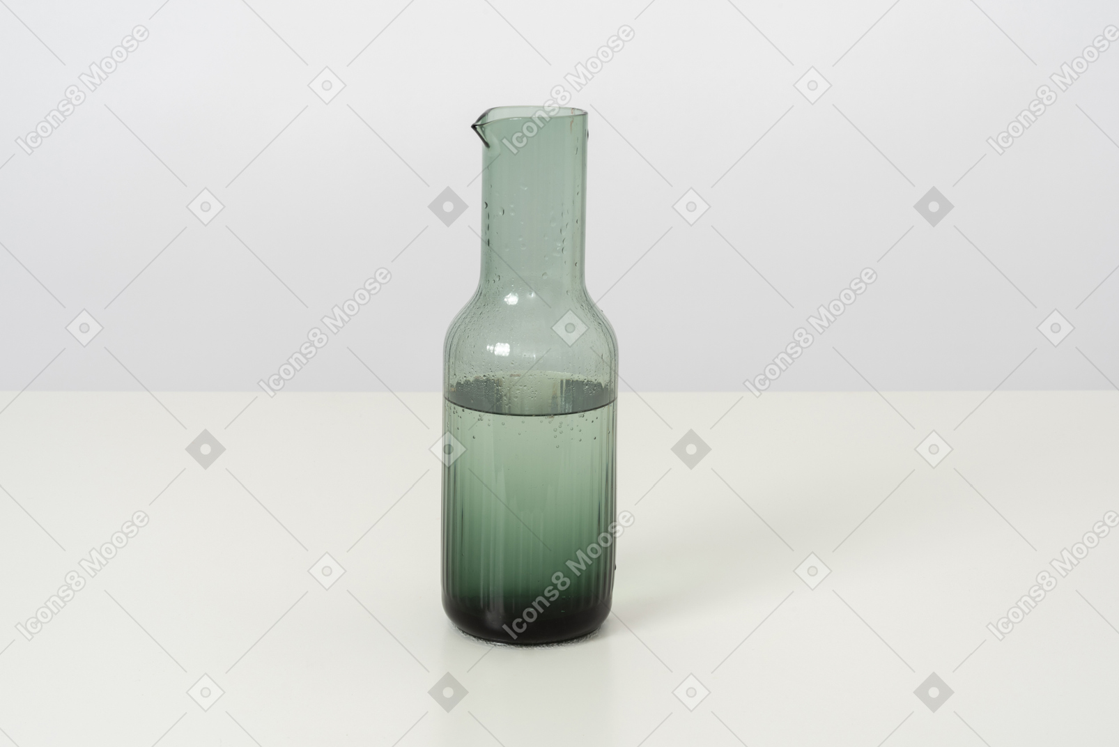 A glass bottle of cold water, designed in a simple style and form
