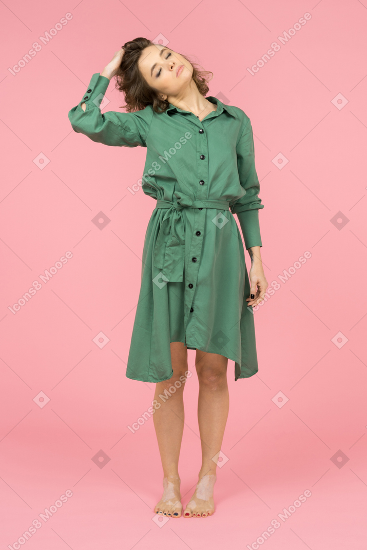 Relaxed young woman standing with closed eyes