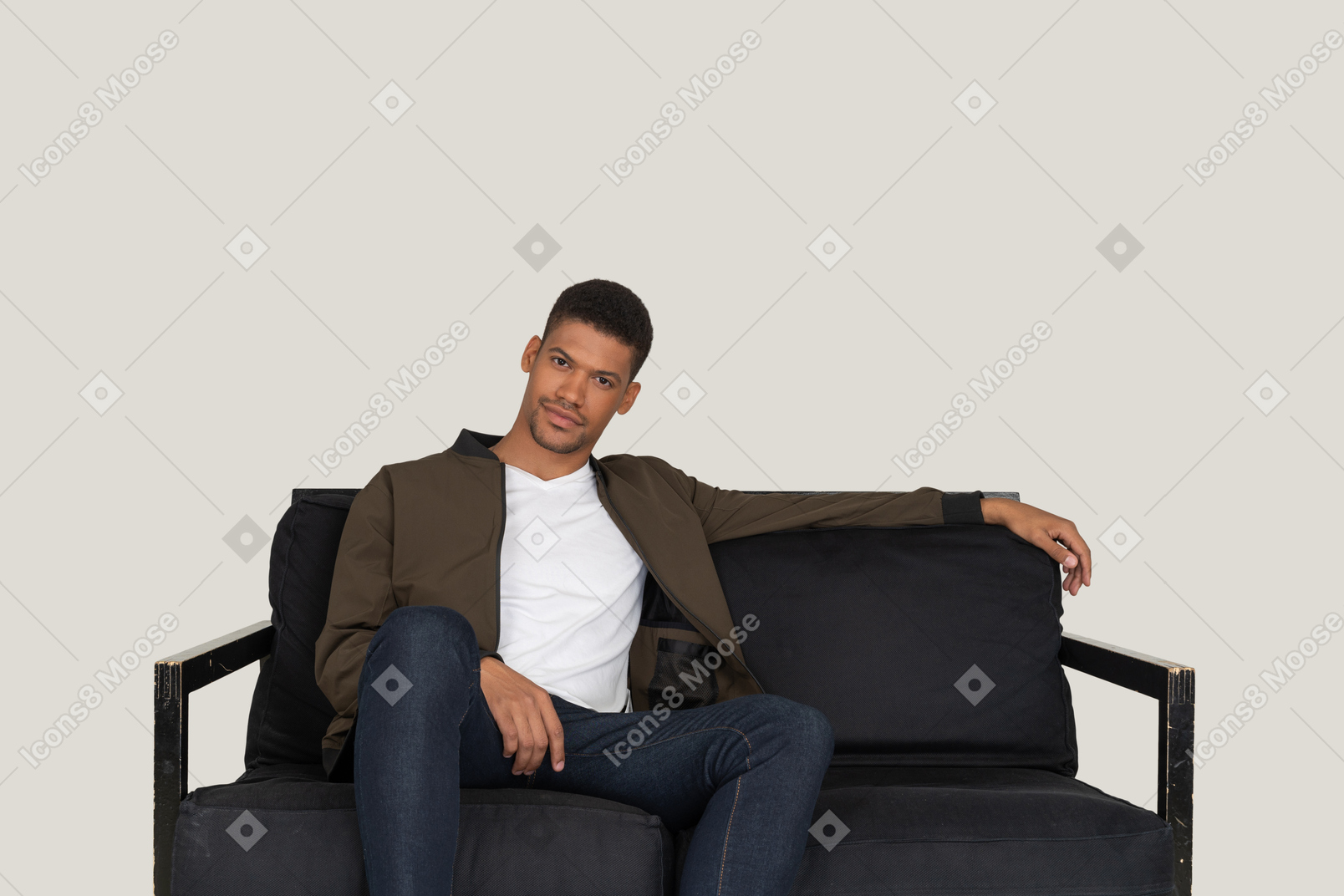 Smiling young man sitting on the sofa