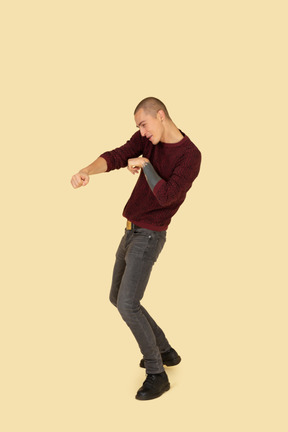 Three-quarter view of a young boxing man in red pullover