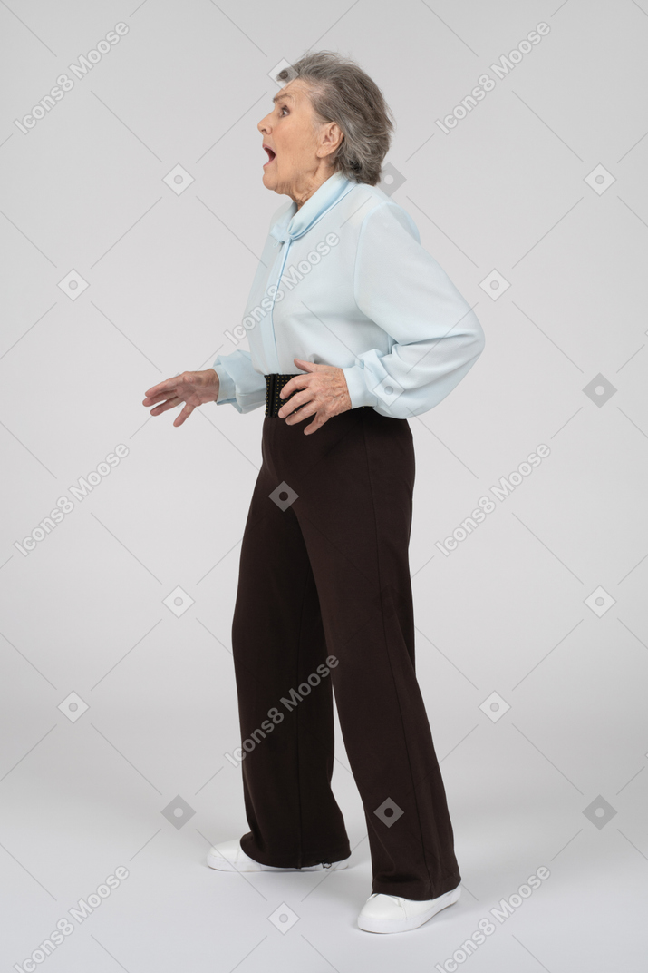 Side view of an old woman gaping in horror to the left