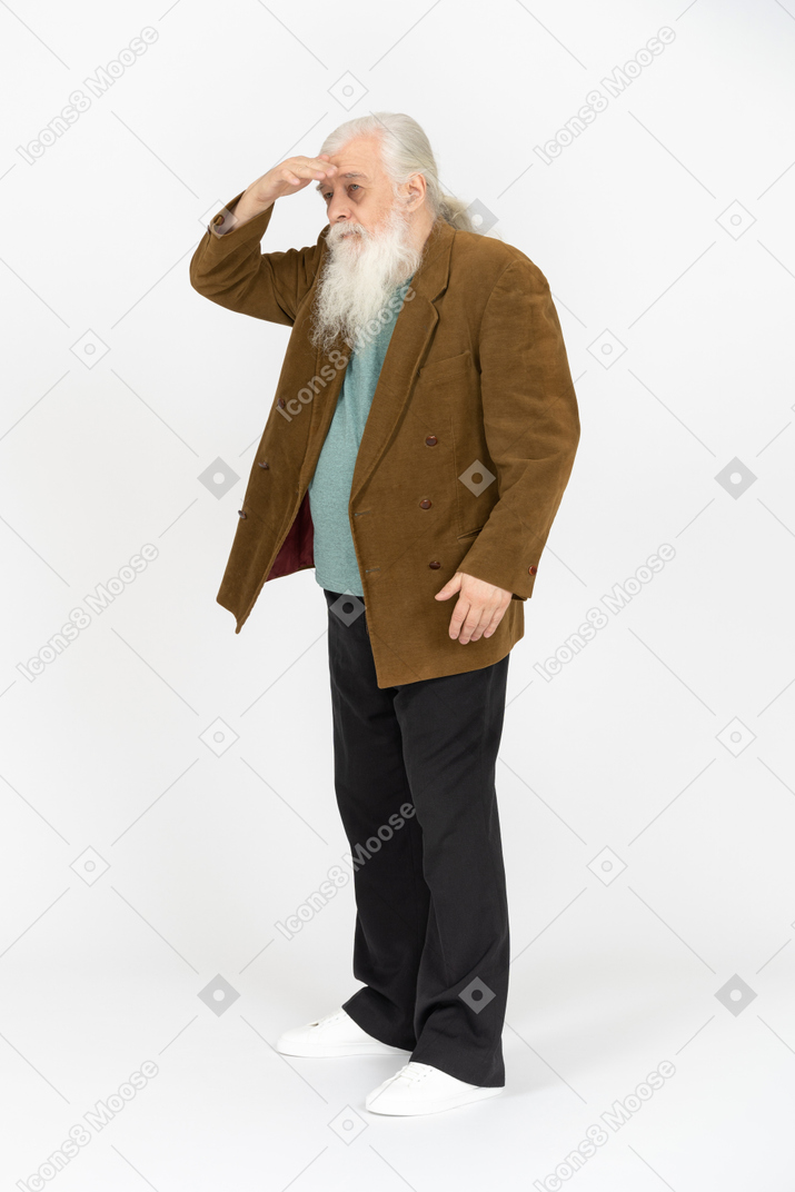 Elderly man shading his eyes from the sun