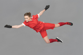 A female goalkeeper in the air