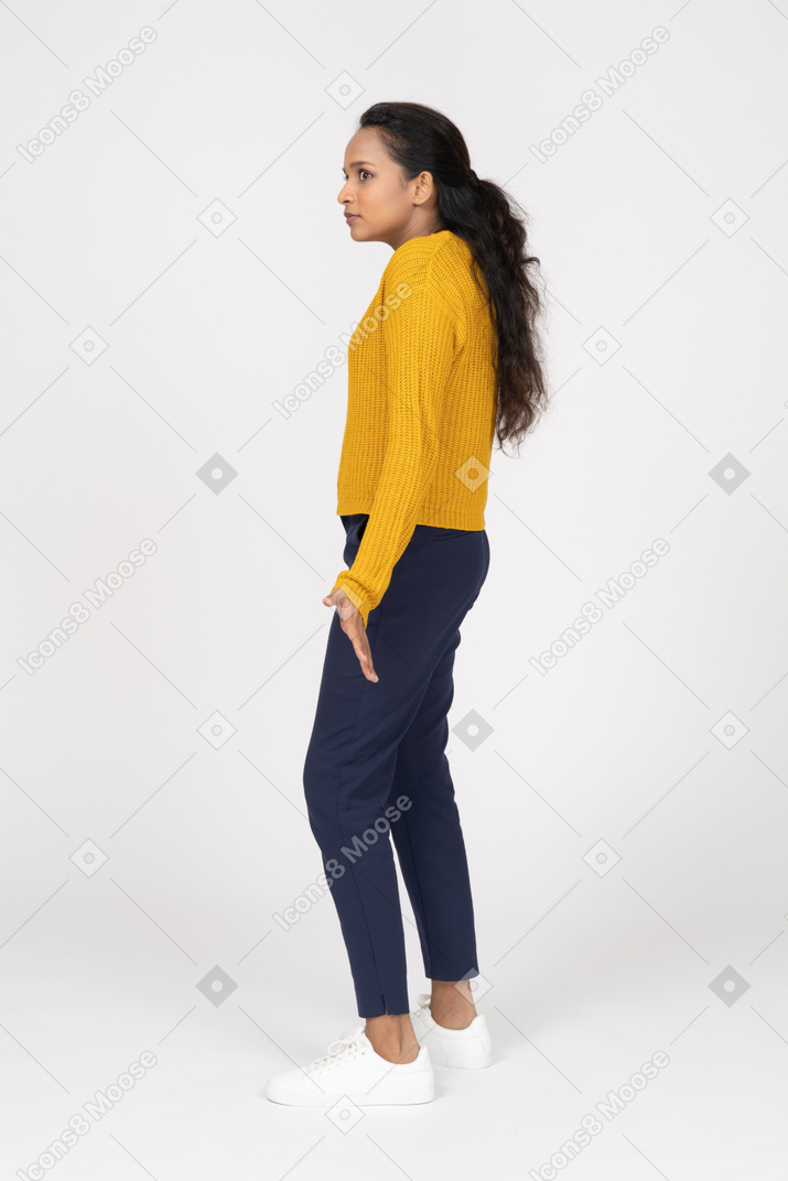Side view of a confused girl in casual clothes