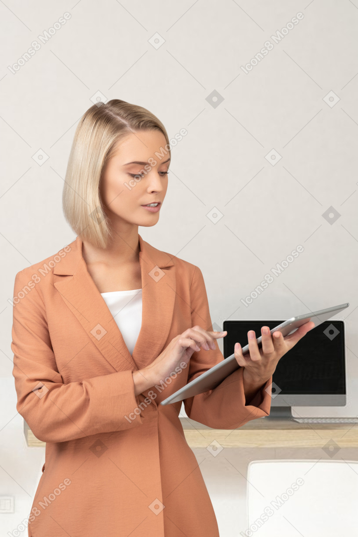 Young woman in a business suit with a laptop