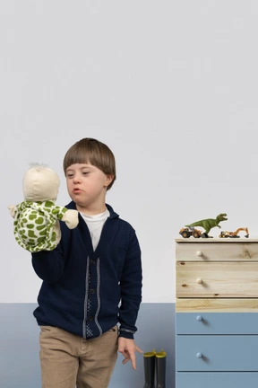 Little boy playing with his turtle puppet