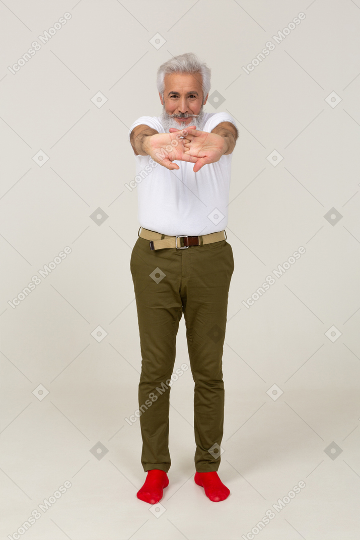 Smiling man in casual clothing doing the stretches
