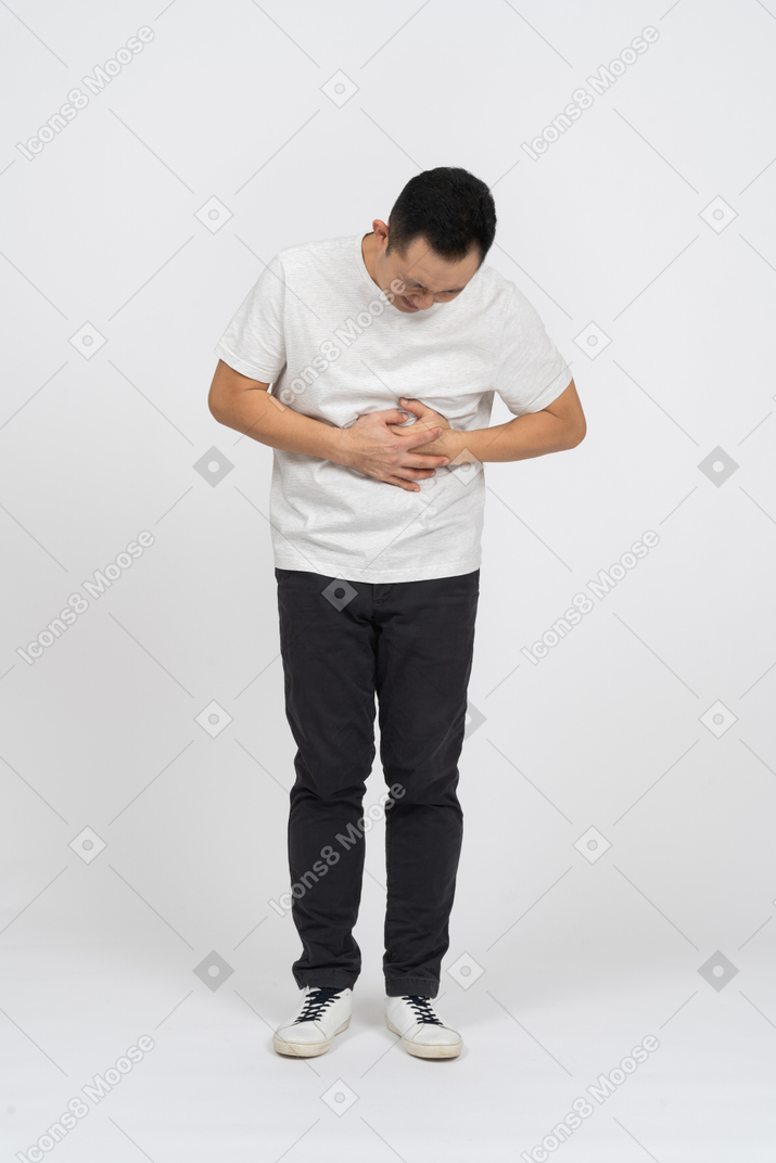 Front view of a man suffering from stomachache