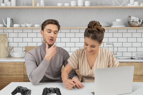 Woman painting nails on a man's hand