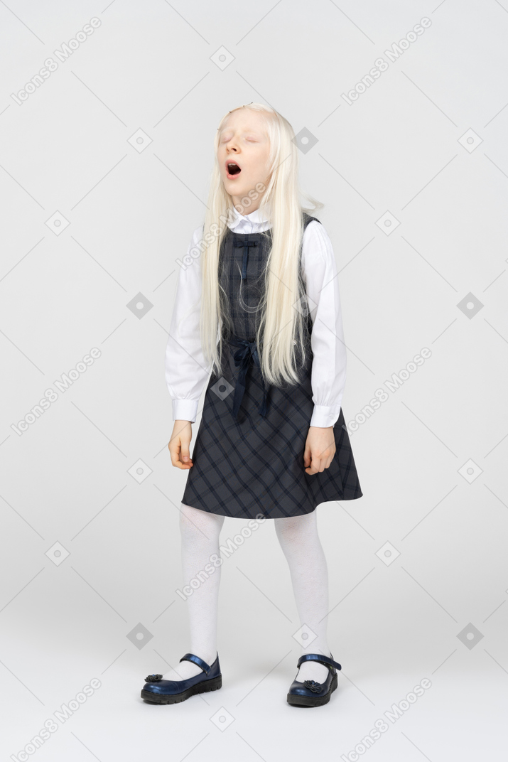 Schoolgirl yawning with her eyes closed