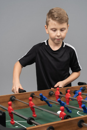 Close-up of a boy playing foosball