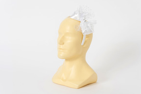 White hairband with a bow on a mannequin head