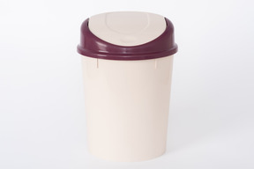 Brown plastic trash bin on white background