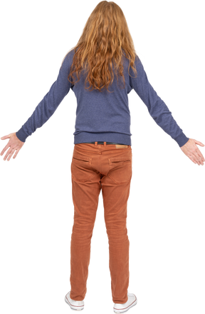 Rear view of a young man standing with outstretched arms