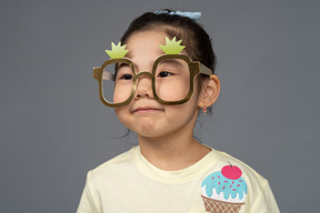 Headshot of a little girl wearing funny glasses